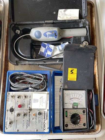 Thermal her Medi check. Inficon refrigerant leak detector powers on. And volt meter.