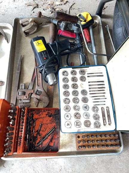 Miscellaneous tool lot featuring tap and die pieces. Heat gun. Various wrenches and miscellaneous.