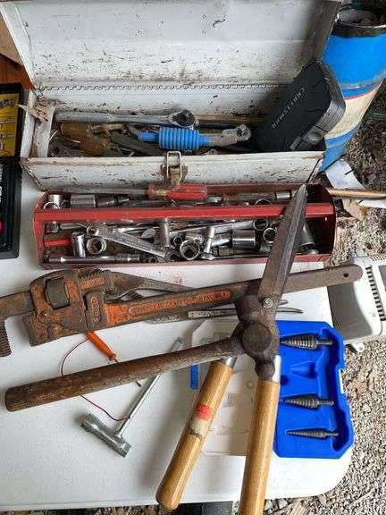 Pole barn. Tool lot featuring large pipe wrench. Shears. Toolbox and wrenches.
