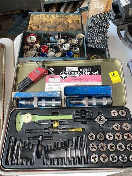 Tap and die set with some missing pieces. Whole saw bits. Drill bits, and miscellaneous items.