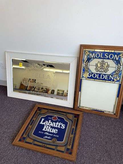 Three import beer signs featuring Molson. La bat blue and Stella Artois. Stella Artois is approximately 36” x 24”.