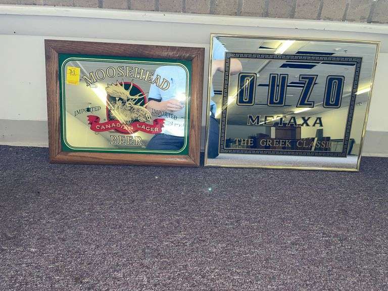 Moose head beer and OUZO mirrored signs. Moose head is approximately 18 x 16”.