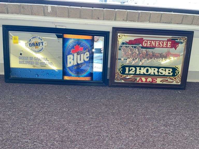 La bat blue and Genesee 12 horse ale mirrored hanging signs. The bat blue is approximately 28” x 16”.