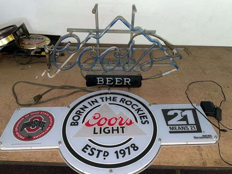 (2) Coors light up beer signs. Neither turn on when plugged in. May need repair or new lightbulbs. Both have plugs. Both are approximately around 30 to 32 inches wide.