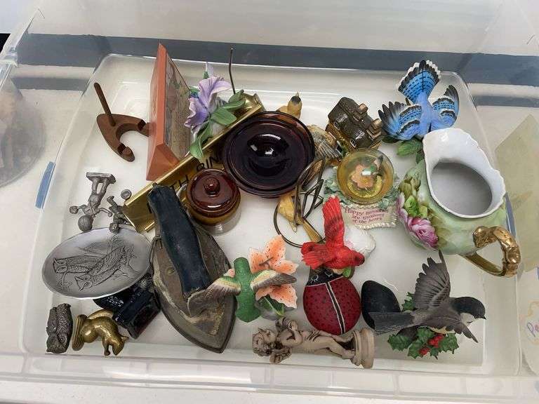 Plastic storage tote filled with miscellaneous figurines and collectibles. Tote is included.