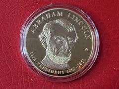 2) Abraham Lincoln Image Changing Coins, 2) Abraham Lincoln Presidential Dollar Trial Coins