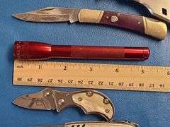 4) Pocket Knives, 1) Small Mag Light