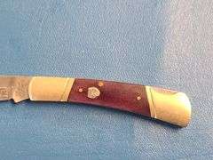 4) Pocket Knives, 1) Small Mag Light