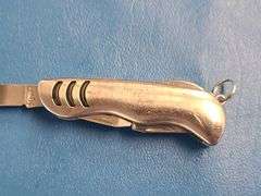 4) Pocket Knives, 1) Small Mag Light