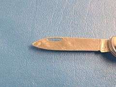 4) Pocket Knives, 1) Small Mag Light