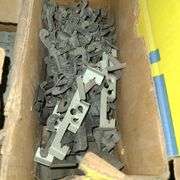 Contents of Under the Table: Fasteners, Metal Stud Clips, Roof Clips and Spacers and More