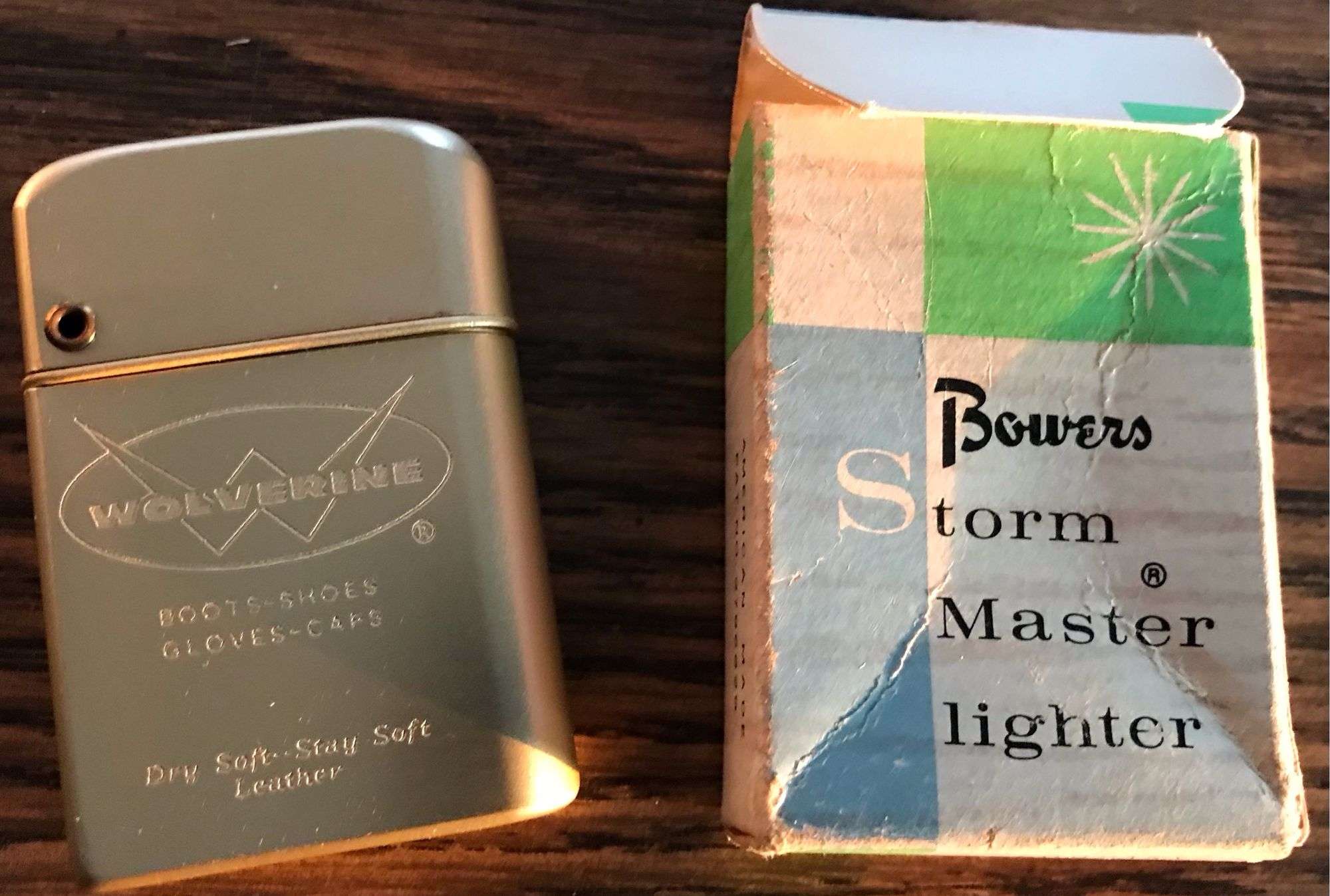 NEW OLD STOCK “BOWERS STORM MASTER” CIGARETTE LIGHTER WITH ADVERTISING FROM  “WOLVERINE”