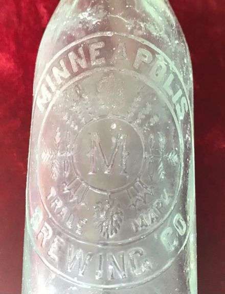 EARLY EMBOSSED BEER BOTTLE FROM “MINNEAPOLIS BREWING CO”