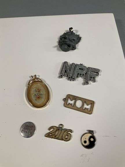 Assorted Costume Jewelry Lot Featuring Earrings, Charms, and Pendants