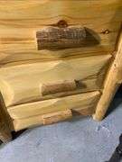 Rustic Pinewood Three-Drawer Nightstand With Natural Log Accents
