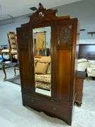 Wooden Armoire with Beveled Mirror and Carved Details