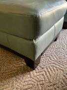Ashley Furniture Sage Green Leather Armchair and Ottoman with Wooden Legs