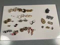 Assorted Costume Jewelry Lot Featuring Earrings, Charms, and Pendants