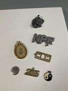 Assorted Costume Jewelry Lot Featuring Earrings, Charms, and Pendants