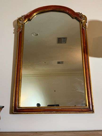 Ornate Mirror With Red and Gold Trim Featuring Scrolled Details