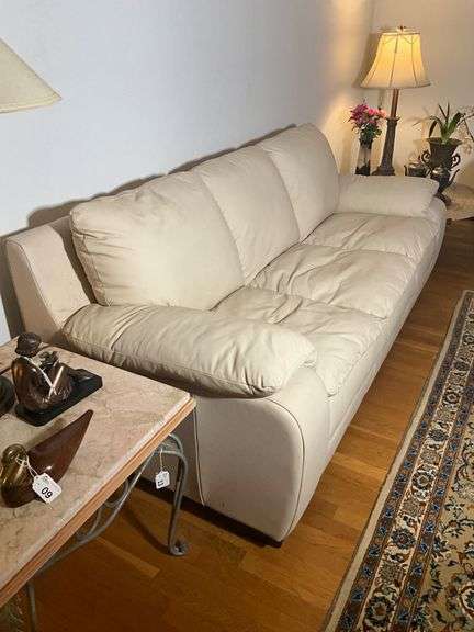 Cream-Colored Leather Sofa with Padded Armrests
