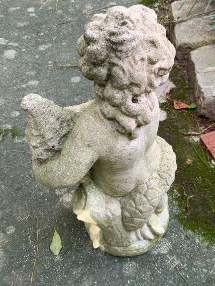 Concrete Figure Holding Seashell