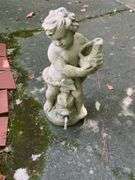 Concrete Figure Holding Seashell