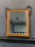 Wood-Framed Mirror with Metal Scrollwork Corners