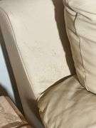 Cream-Colored Leather Sofa with Padded Armrests