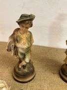 Four Chalkware Figurines Including Boy, Girl, and Two Reclining Cherubs