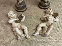Four Chalkware Figurines Including Boy, Girl, and Two Reclining Cherubs