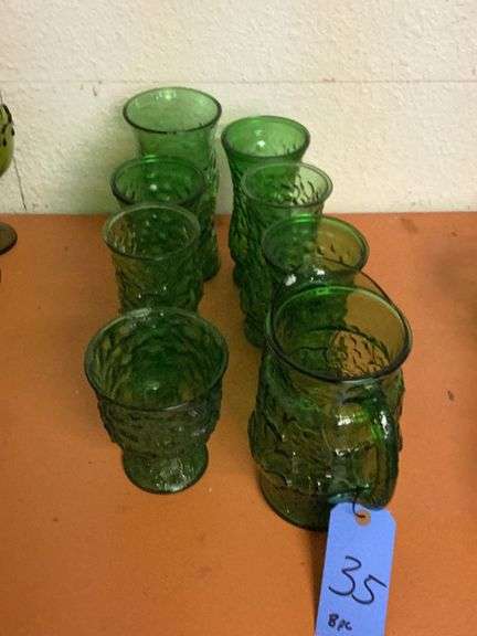 8 pieces of green glass with a pitcher