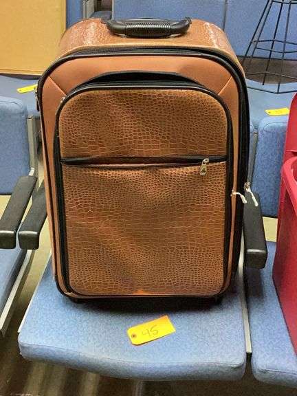 Brown luggage case on wheels