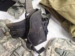 Four tactical vests, duffelbag and drop leg holster