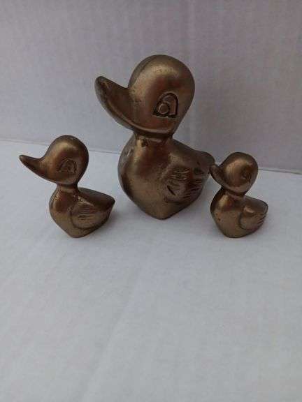 Three brass ducks