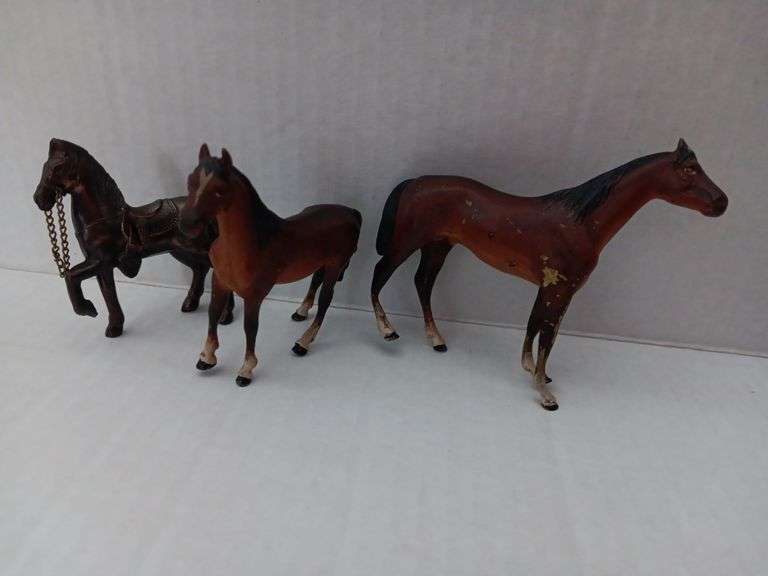 Two cast iron or lead horses and brownstone horse