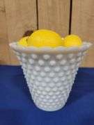 Vase and artificial lemons.