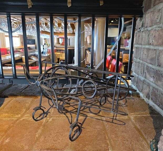 wrought iron airplane-shaped wine bottle holder.