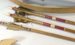 CARVED WOODEN CLUBS, BOW & ARROWS, ETC.