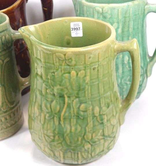 FOUR ANTIQUE STONEWARE PITCHERS