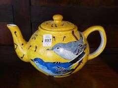 FOUR HAND-PAINTED TEAPOTS