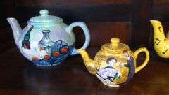 FOUR HAND-PAINTED TEAPOTS