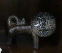 TWO POTTERY FIGURINES AND METAL SCULPTURE