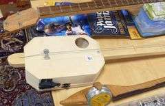 THREE HOMEMADE INSTRUMENTS AND WALL ART