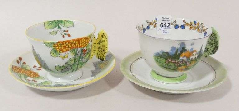 TWO BUTTERFLY HANDLE CUPS AND SAUCERS