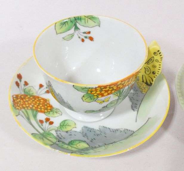 TWO BUTTERFLY HANDLE CUPS AND SAUCERS