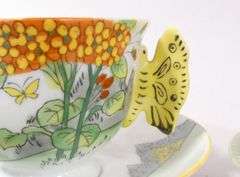TWO BUTTERFLY HANDLE CUPS AND SAUCERS