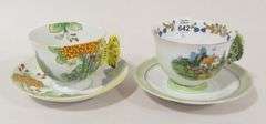 TWO BUTTERFLY HANDLE CUPS AND SAUCERS
