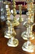 TWO PAIRS OF ANTIQUE BRASS CANDLESTICKS