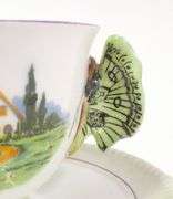 TWO BUTTERFLY HANDLE CUPS AND SAUCERS